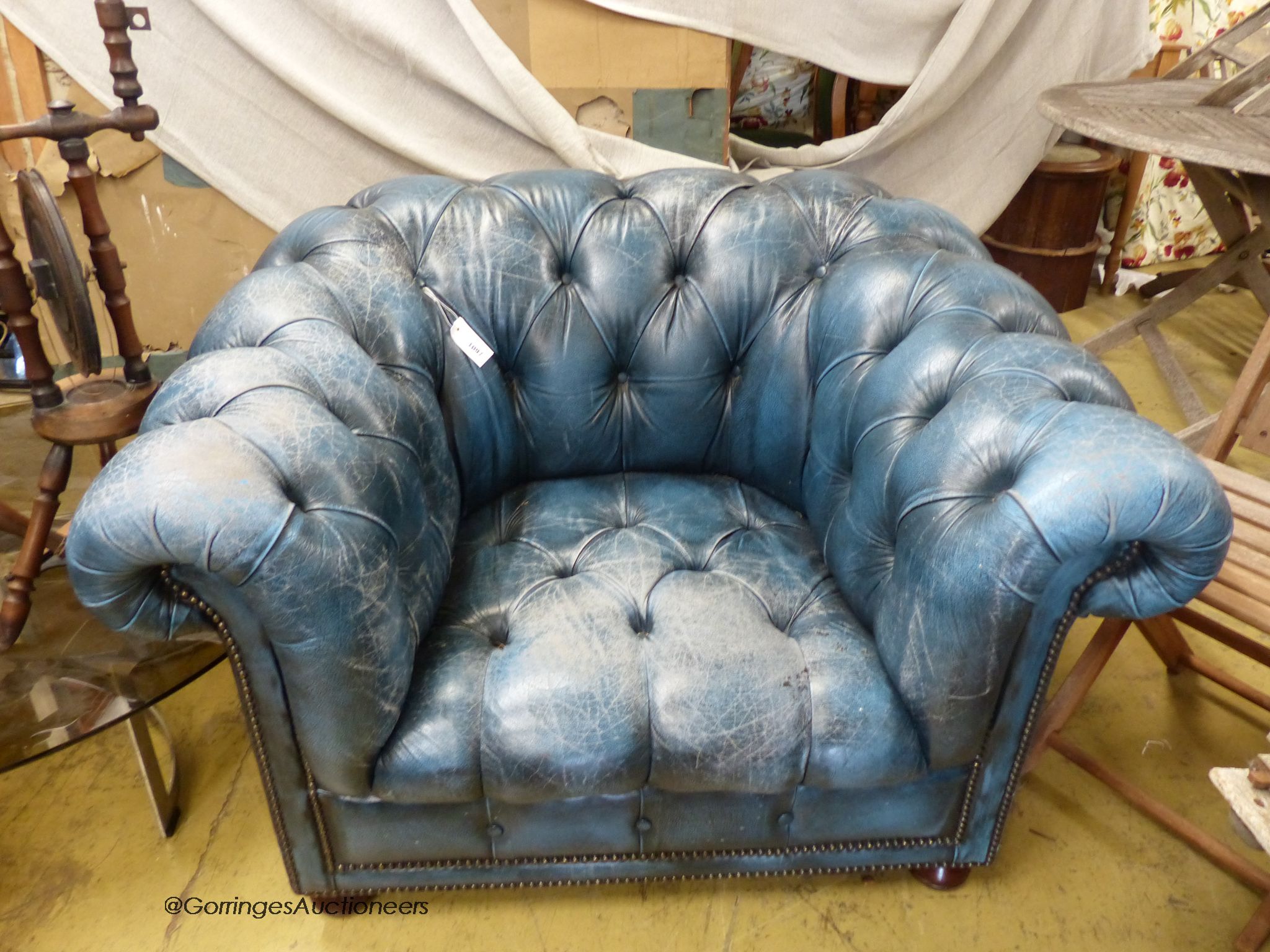 Victorian style, buttoned blue leather chesterfield armchair.